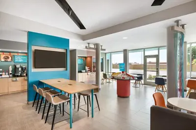 a dining room with a table and chairs at avid hotel - Ft Lauderdale Airport - Cruise by IHG in Fort Lauderdale