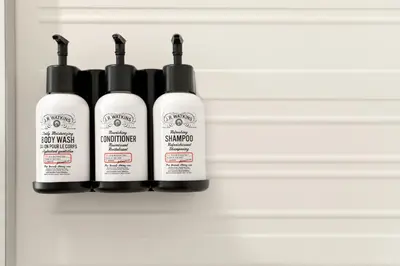 a group of four hair products sitting on a shelf at avid hotel - Ft Lauderdale Airport - Cruise by IHG in Fort Lauderdale