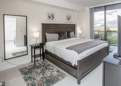 a bedroom with a large bed and a large window at Luxury 2BD Apartment in Downtown Doral in Miami