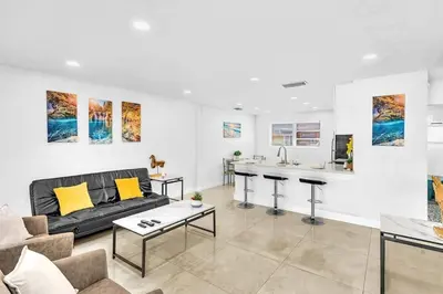 a living room with a couch and a table at Modern 2br Near Aventura Mall & Sunny Beach in Hallandale Beach