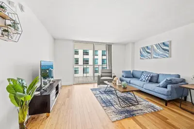 a living room with a blue couch and a tv at Luxury 1 Bedroom Apartment • Brickell • City and Ocean View in Miami
