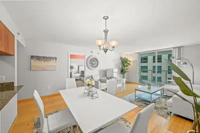 a dining room and living room with a white table and chairs at Luxurious 1 Bed Apartment • Brickell • Ocean Views in Miami