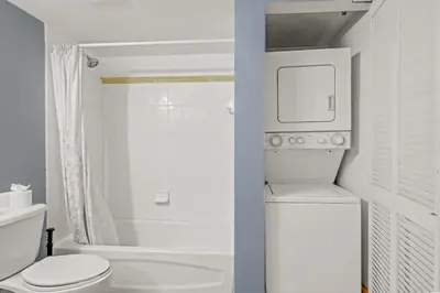 a white bathroom with a toilet and a shower at Luxurious 1 Bed Apartment • Brickell • Ocean Views in Miami