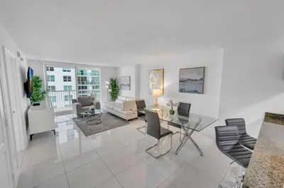 a living room with a glass table and chairs at Luxury 1 Bedroom Apartment • Brickell • Unique Views in Miami