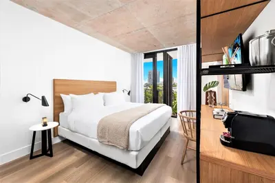 a hotel room with a bed and a window at Upsun Hotel in Miami Beach