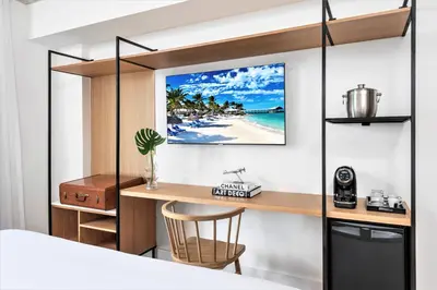 a bedroom with a desk and a view of the beach at Upsun Hotel in Miami Beach