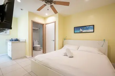 a bedroom with a white bed and a bathroom at Casa Del Mar Master in Hollywood
