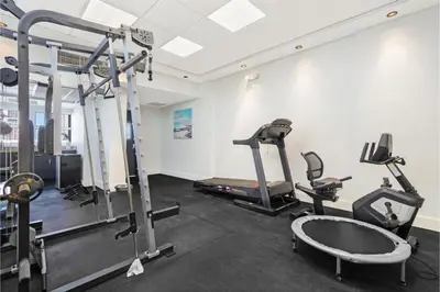 a gym with two tread machines and a treadmill at Roami at Sunny Isles in Miami Beach