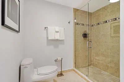 a bathroom with a toilet and a shower at Roami at Sunny Isles in Miami Beach