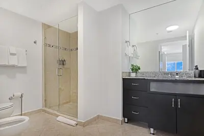 a bathroom with a shower and a toilet and a sink at Roami at Sunny Isles in Miami Beach