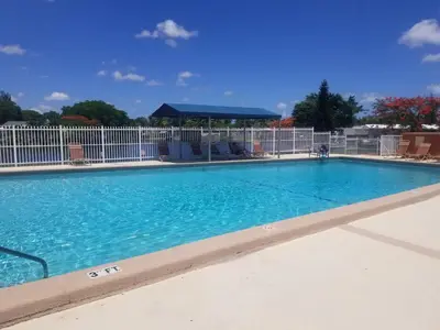 a swimming pool at a resort with blue water at 1161 Studio 2 Main Miami in Miami