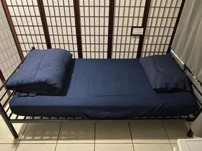 a large blue bed in a small room at Private Cubicle - Single Bed - Mixed Shared Dorm - MIAMI AIRPORT in Miami