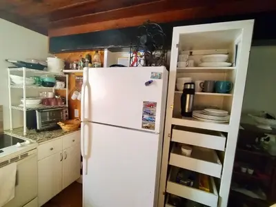 a white refrigerator in a kitchen with a shelf at Cozy apartment in quite zone in Hollywood