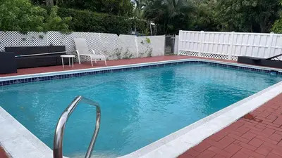 a large swimming pool with a metal handrail in a yard at Cozy apartment in quite zone in Hollywood