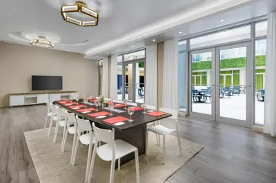 a dining room with a long table and chairs at Costa Hollywood Beach Resort - An All Suite Hotel in Hollywood