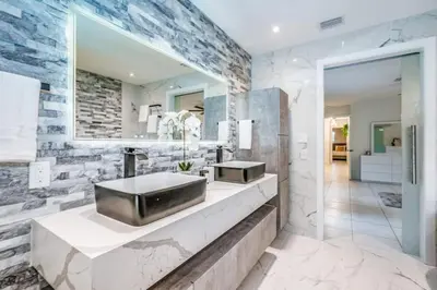 a bathroom with a sink and a mirror at Lux House Heated Spa & Free Boat Tour! in Fort Lauderdale