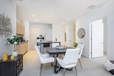 a kitchen and dining room with a table and white chairs at Hyde Beach House Luxury Condo-Resort condo in Hollywood Beach