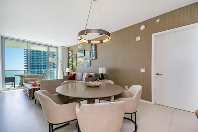 a living room with a table and chairs at Hyde Beach Luxury Condo-Resort apts in Hollywood Beach