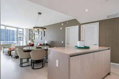 a kitchen and living room with a table and chairs at Hyde Beach Luxury Condo-Resort apts in Hollywood Beach