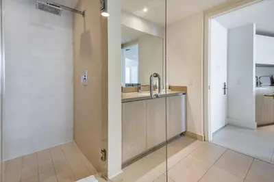 a bathroom with a shower and a sink and a mirror at Hyde Beach Luxury Condo-Resort apts in Hollywood Beach