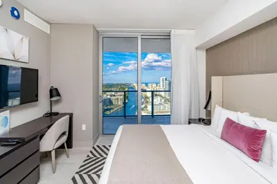 a hotel room with a bed and a large window at Hyde Beach House Luxury Condo-Resort condo in Hollywood Beach