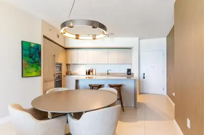 a kitchen with a table and chairs in a room at HYDEOV1BR - Unit 1910 - Ammos condo in Hollywood Beach