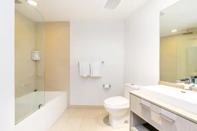 a white bathroom with a tub and a toilet and a sink at HYDEOV1BR - Unit 1910 - Ammos condo in Hollywood Beach