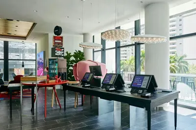 a room with a table with laptops on it at citizenM Miami Brickell in Miami