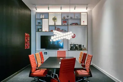 a dining room with a black table and red chairs at citizenM Miami Brickell in Miami