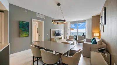 a dining room and living room with a table and chairs at 2 bed rental on the beach15th floor Hollywood Miami in Hallandale Beach
