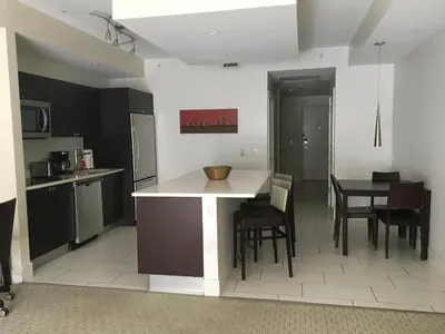 a kitchen with a counter and a table and chairs at Doral 2-Story Villa 3 Bed 4 Bath at Provident Doral at The Blue Miami in Miami
