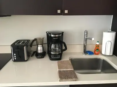 a kitchen counter with a sink and a coffee maker at Doral 2-Story Villa 3 Bed 4 Bath at Provident Doral at The Blue Miami in Miami