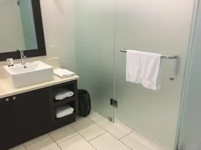 a bathroom with a sink and a shower with a mirror at Doral 2-Story Villa 3 Bed 4 Bath at Provident Doral at The Blue Miami in Miami