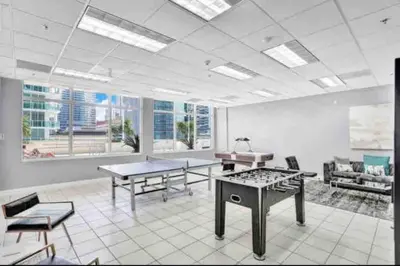 a large room with tables and chairs and windows at Private Unit Miami With Amenities And Parking in Miami