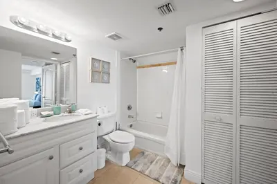 a white bathroom with a toilet and a sink and a shower at Private Unit Miami With Amenities And Parking in Miami