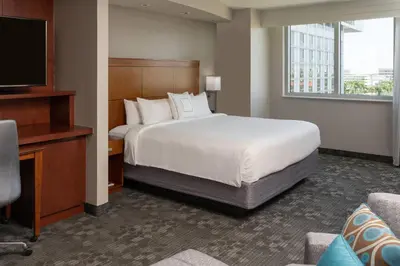 a hotel room with a bed and a television at Courtyard by Marriott Miami Airport in Miami