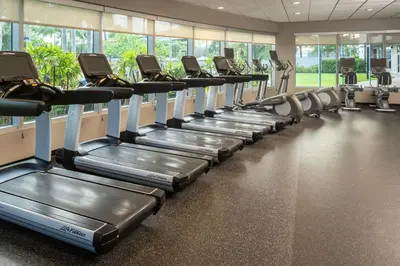 a row of tread machines in a gym at Courtyard by Marriott Miami Airport in Miami
