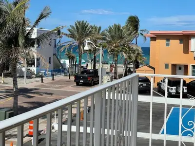 a view of a street with palm trees and a parking lot at The Tel in Hollywood