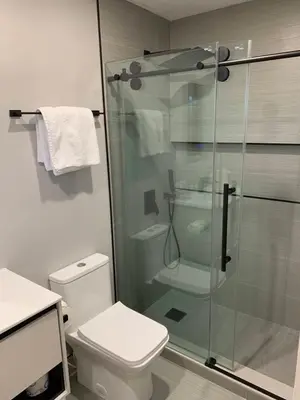 a bathroom with a toilet and a glass shower at The Tel in Hollywood
