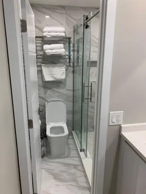 a bathroom with a toilet and a glass shower at The Tel in Hollywood