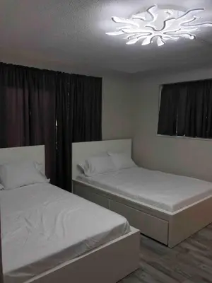 a bedroom with two beds and a chandelier at The Tel in Hollywood