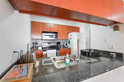 a kitchen with a sink and a refrigerator at Gorgeous Apartment in Brickell in Miami