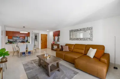 a living room with a brown couch and a table at Gorgeous Apartment in Brickell in Miami