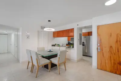 a kitchen and dining room with a table and chairs at Gorgeous Apartment in Brickell in Miami