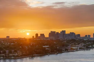a city skyline at sunset with the sun setting at W Fort Lauderdale in Fort Lauderdale