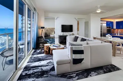 a living room with white furniture and a view of the ocean at W Fort Lauderdale in Fort Lauderdale