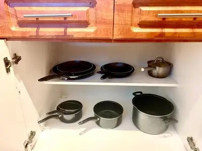 a kitchen with pots and pans on a shelf at Castle Beach Resort Condo - Panoramic Large Penthouse or Deluxe 1 BR Direct Ocean View and beach access- Updated-Free parking- in Miami Beach