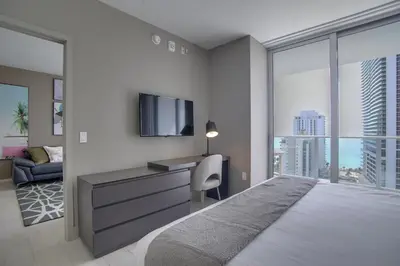 a bedroom with a large bed and a tv at Upscale Condo with Pool Access in Hyde Beach House! in Hollywood