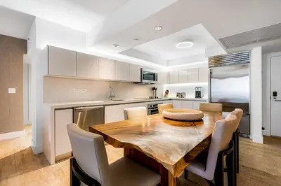 a kitchen with a wooden table and chairs at Oceanview Private Condo at 1 Hotel & Homes -1115 in Miami Beach