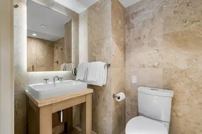 a bathroom with a sink and a toilet and a mirror at Oceanview Private Condo at 1 Hotel & Homes -1115 in Miami Beach